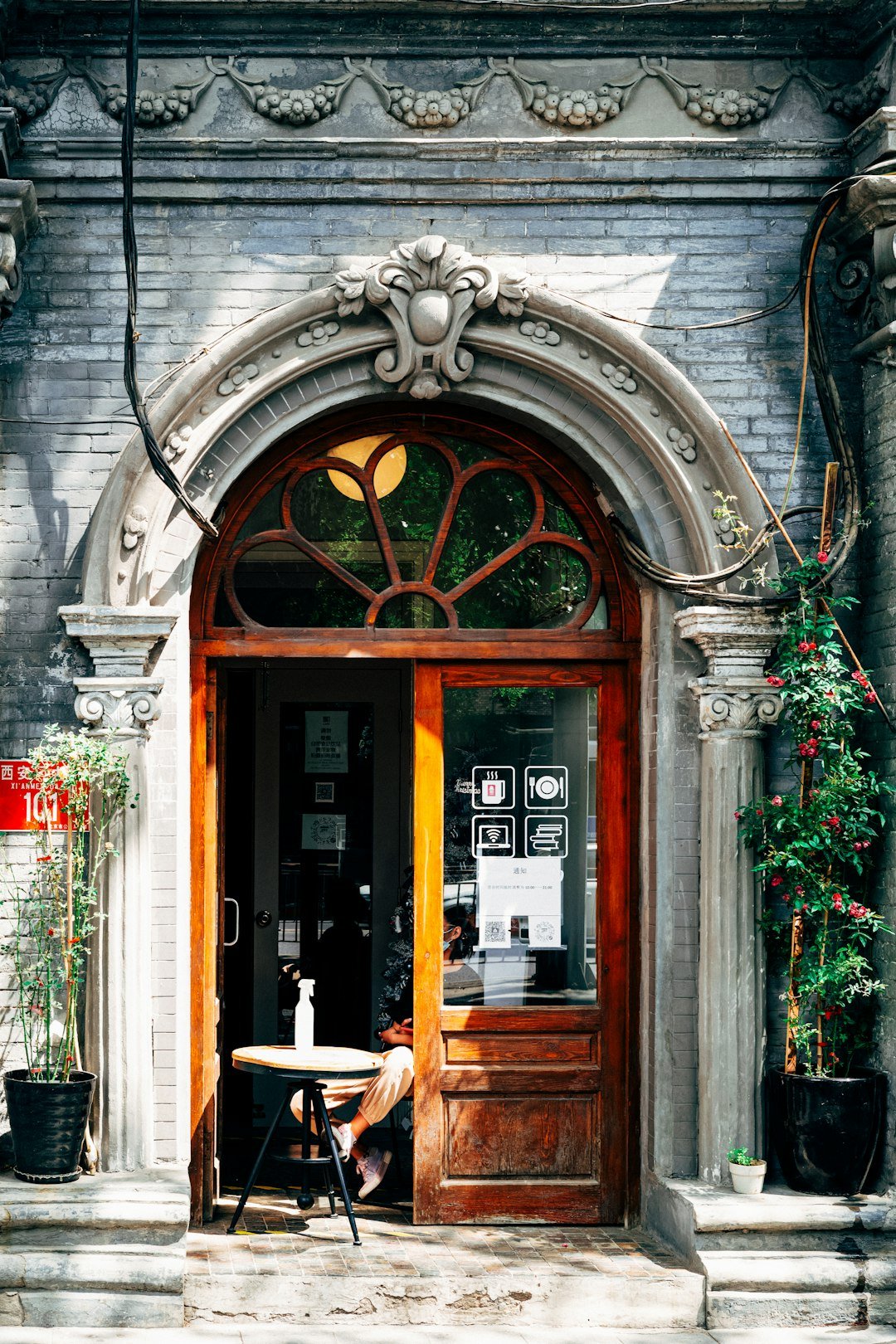 a person sitting at a table outside a building